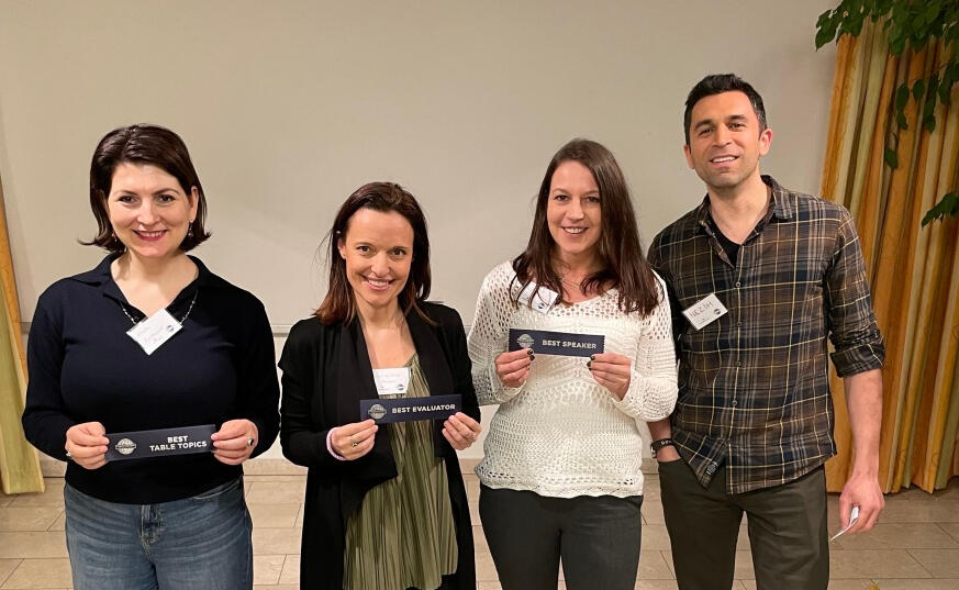 Winners of the evening people holding winners badges in their hands