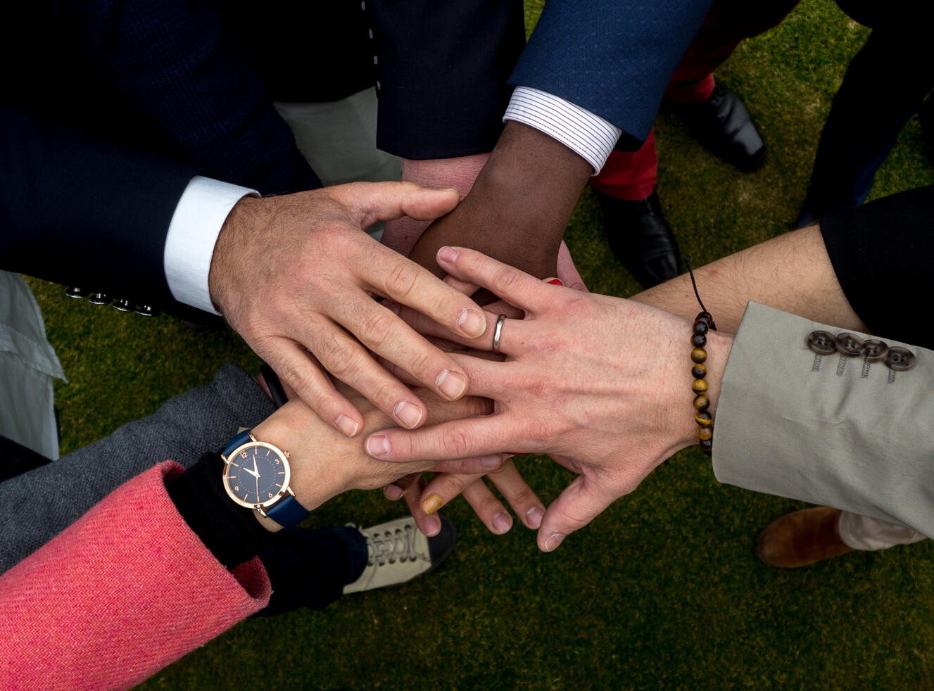 Together an image showing hands from different people stacking on top of each other